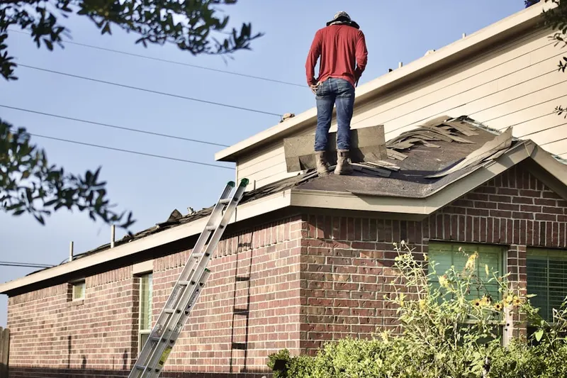 Professional roofer working on a residential roof in Lillyville